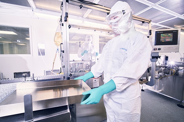 Scientist wearing maximum protection coverall with gloves